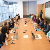 A diverse team of tech entrepreneurs collaborating on growth strategies around a modern office table
