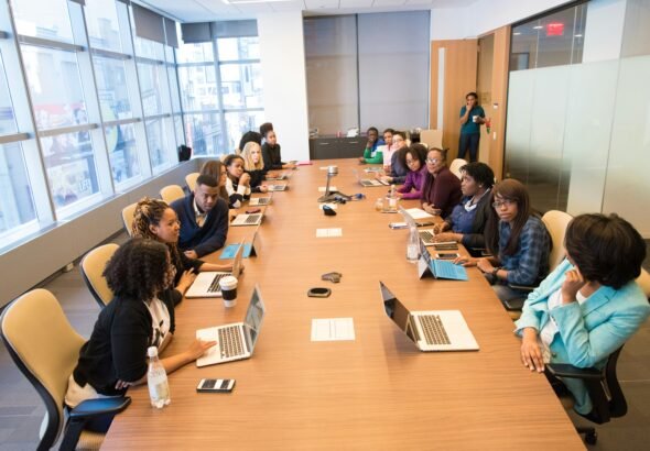 A diverse team of tech entrepreneurs collaborating on growth strategies around a modern office table