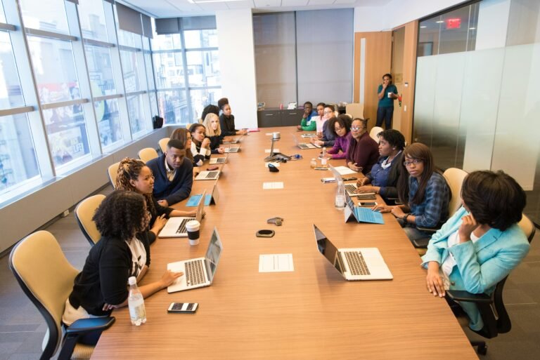 A diverse team of tech entrepreneurs collaborating on growth strategies around a modern office table