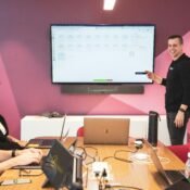 Digital marketing team analyzing campaign data on computer screens