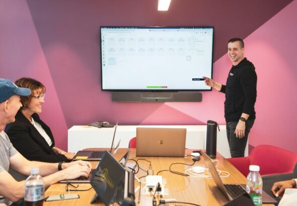 Digital marketing team analyzing campaign data on computer screens