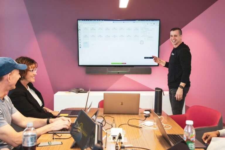 Digital marketing team analyzing campaign data on computer screens