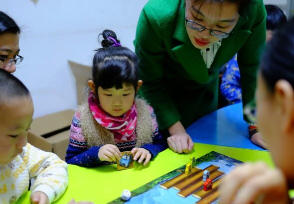 Teacher implementing a play-based toddler curriculum in classroom