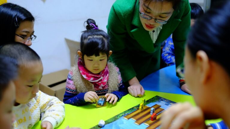 Teacher implementing a play-based toddler curriculum in classroom