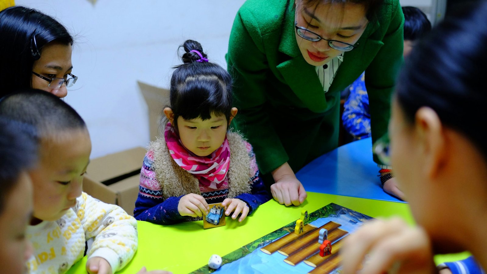 Teacher implementing a play-based toddler curriculum in classroom